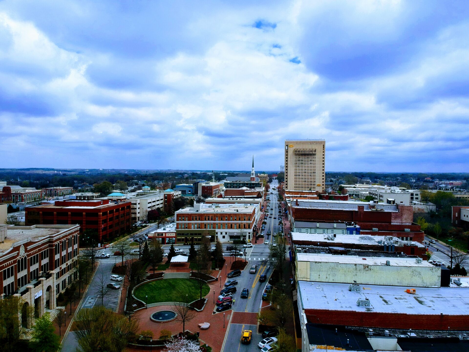 Aerial view of Huntsville, Alabama cityscape with downtown buildings under a cloudy sky.