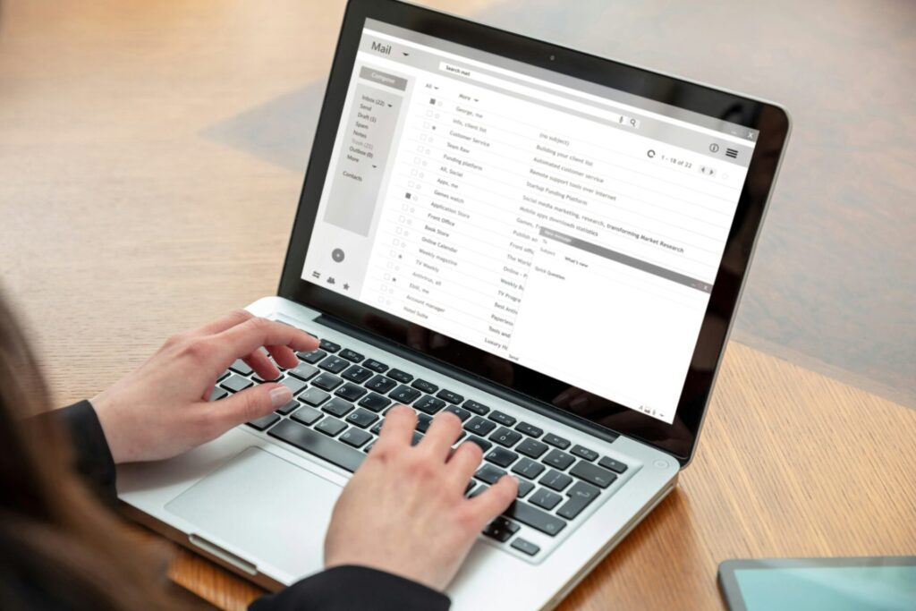 Email client list, woman hand on the computer laptop, inbox e mail message on the screen, close up