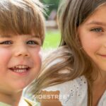 Smiling young boy and girl enjoying a sunny day outside, captured in bright, natural light.