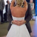 Bride and groom share a romantic first dance at their wedding reception.