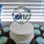 Space-themed first birthday cake with blue frosting cupcakes and one topper.